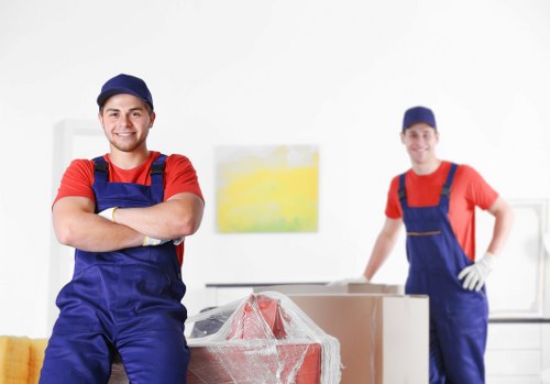 Professional movers handling office equipment